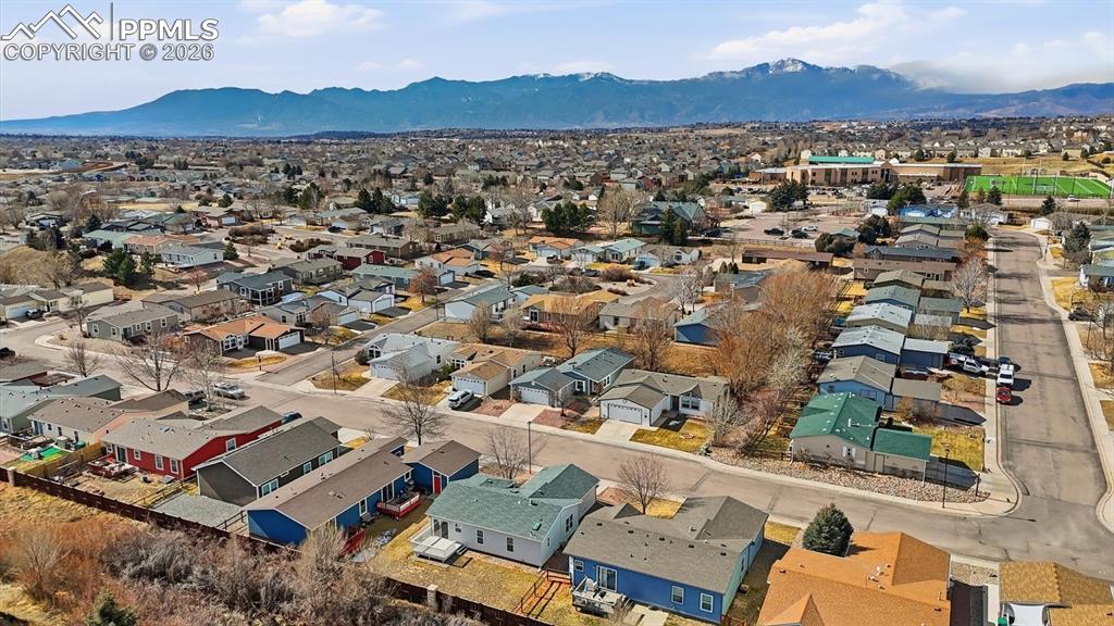 Aerial view of home, neighborhood, and mountains.