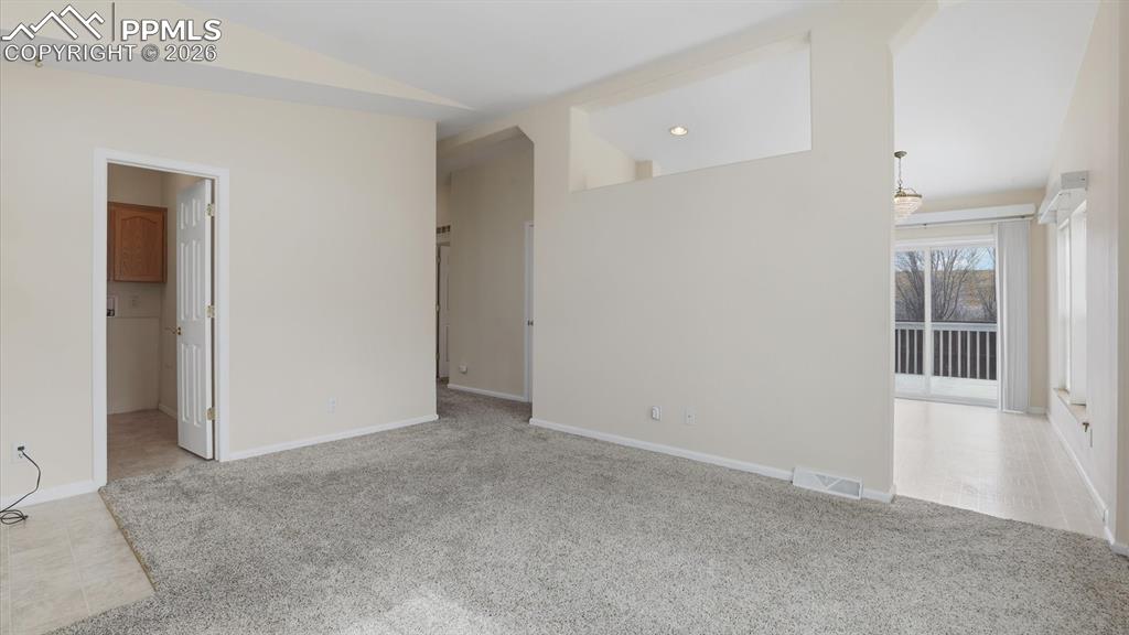 View of the Laundry Room, hallway to bedrooms and bathroom, and Kitchen/Dining Area from the Living Room.