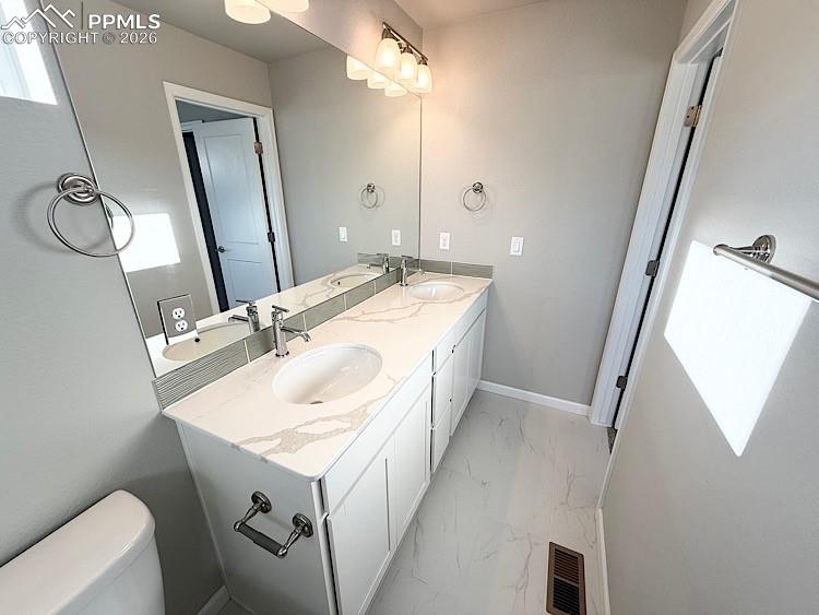 Primary Bathroom with dual vanities, Quartz countertop, and tile surrounds!