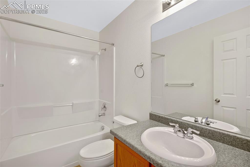 Bathroom with vanity and washtub / shower combination