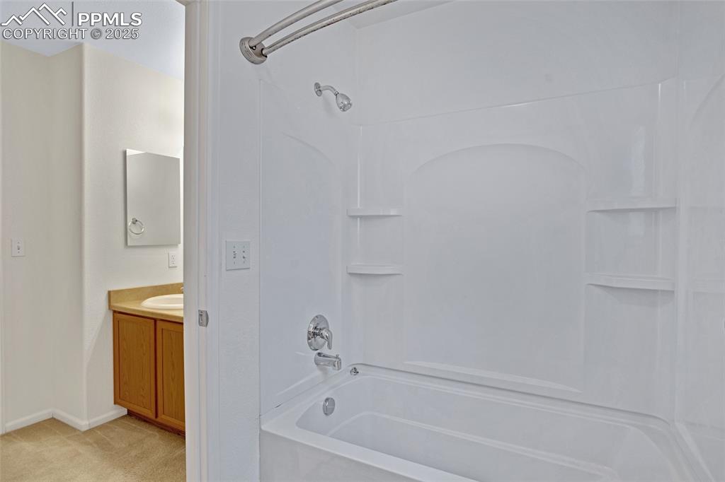 Full bathroom with shower / bath combination and vanity