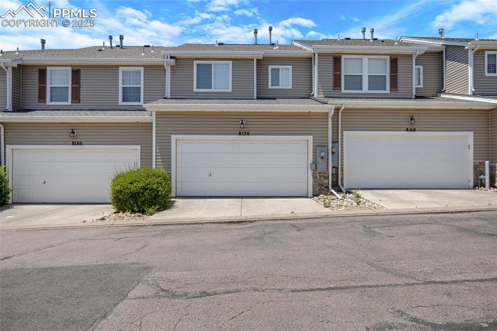 View of property with an attached garage and driveway