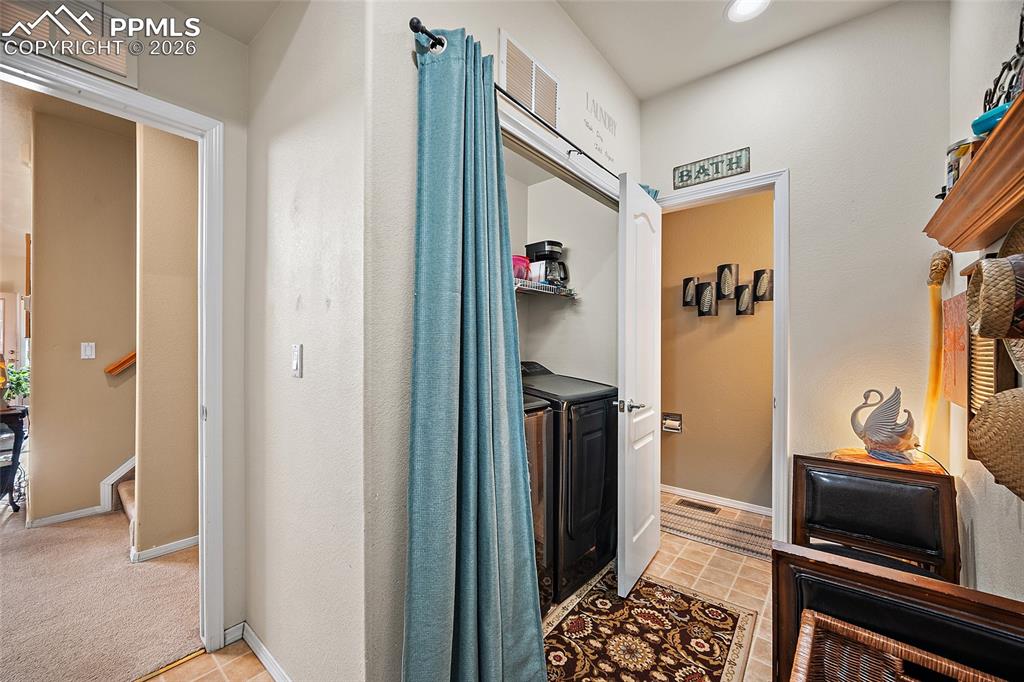 Entry from garage sitting area to remove shoes, laundry and powder room. 