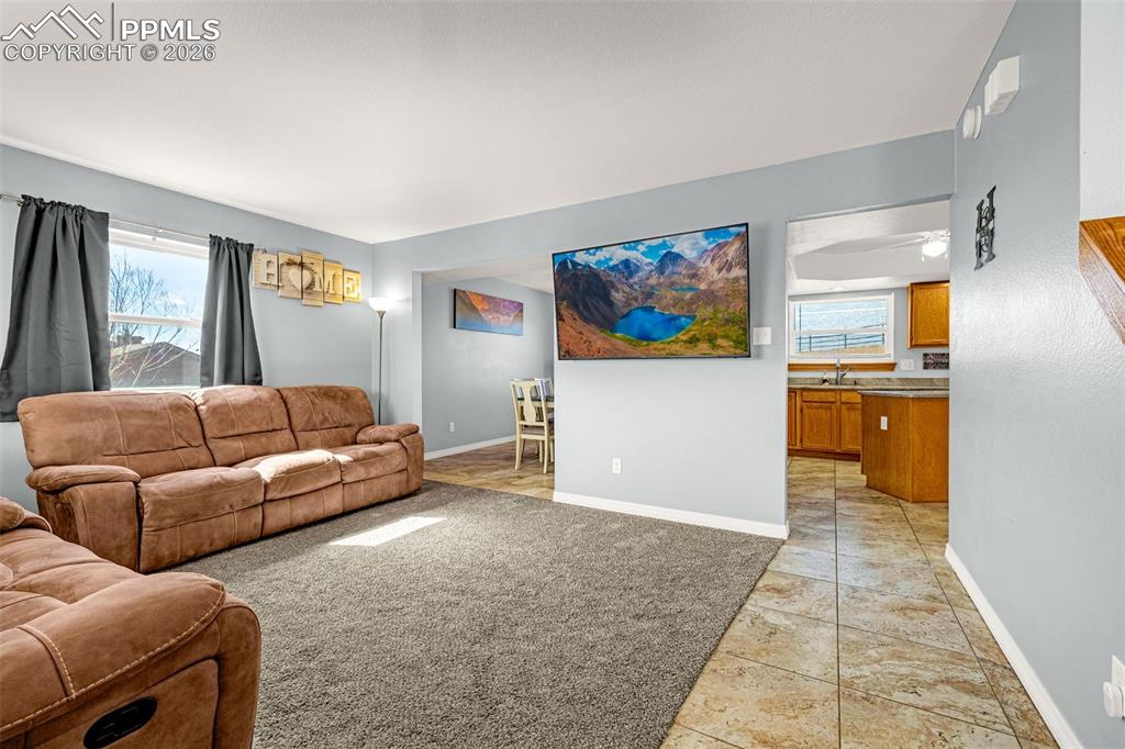 Living area featuring baseboards and light tile patterned floors