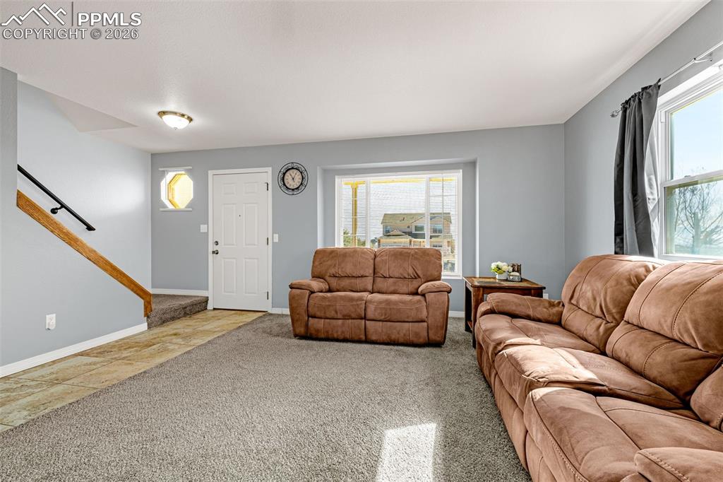 Living area with carpet and baseboards