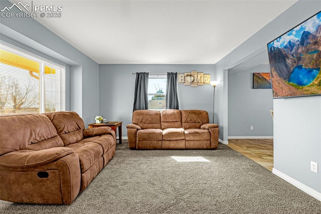 Living room with carpet flooring and baseboards