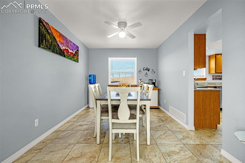 Dining space featuring a ceiling fan and plenty of natural light
