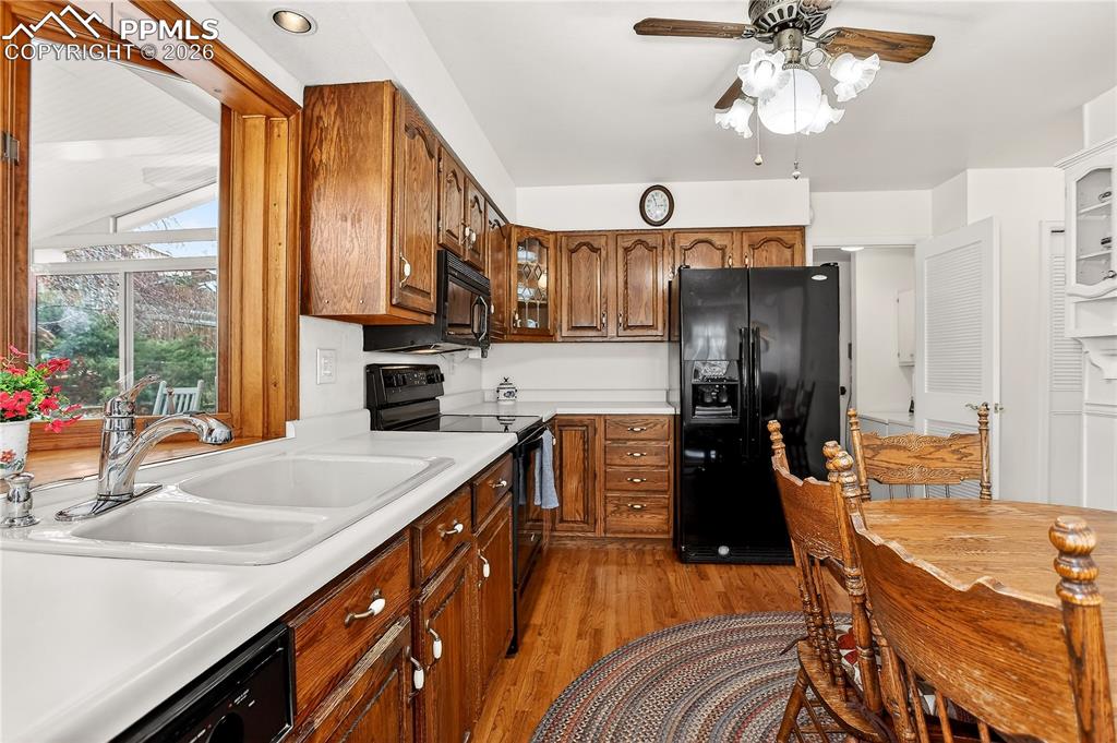 Kitchen looks out over expansive sunroom. Laundry and garage entrance is through door next to fridge.