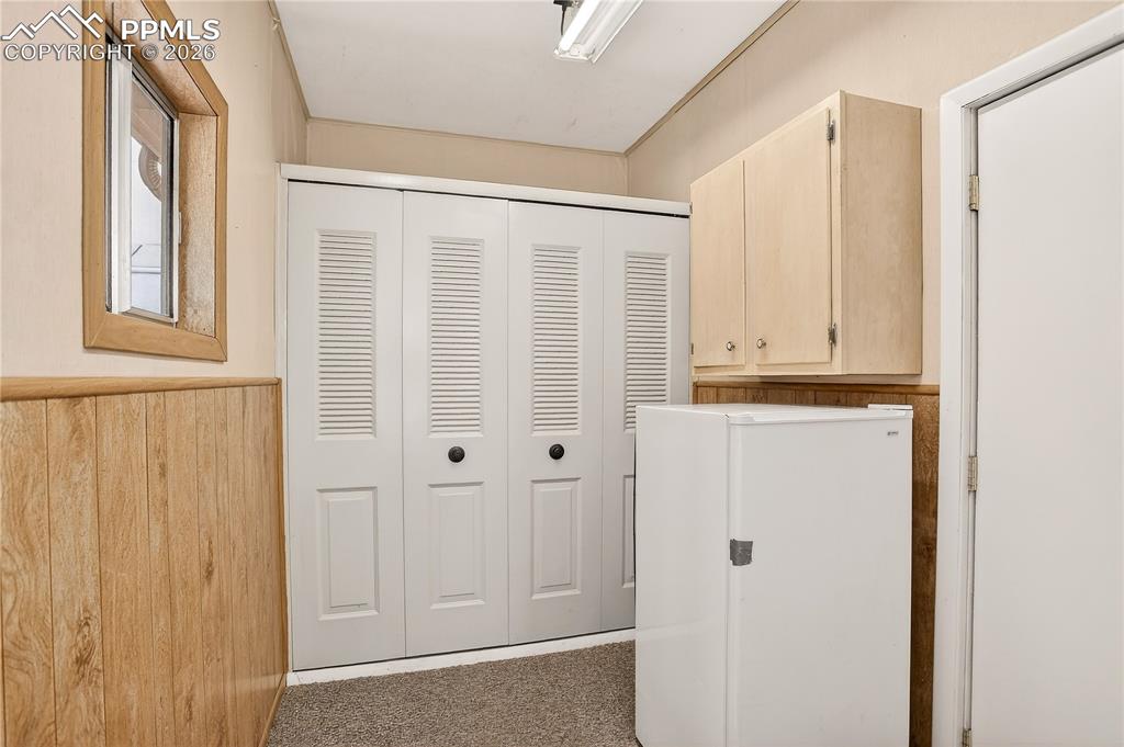 Laundry/storage area. Door on the right leads to the garage.