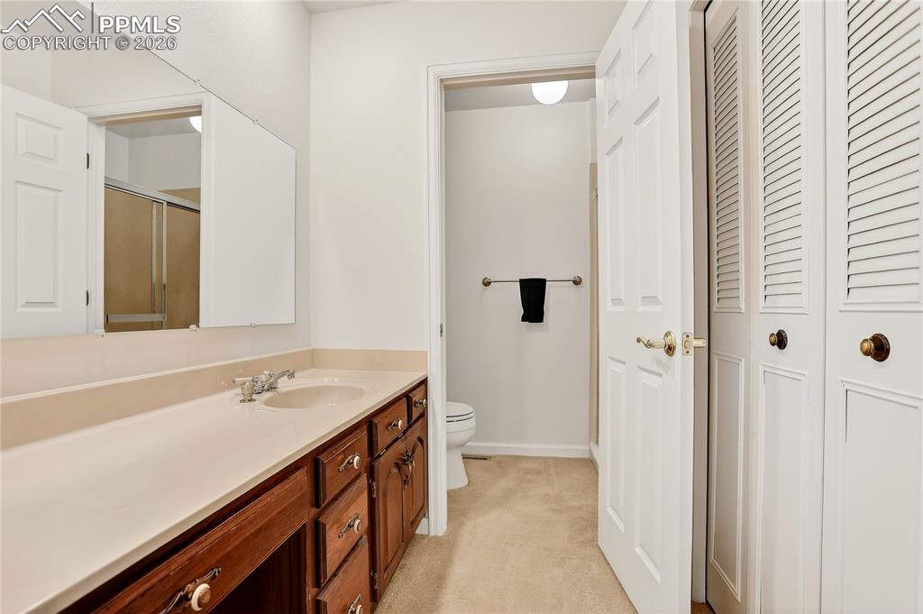 Primary bathroom has plenty of storage and a walk-in shower.