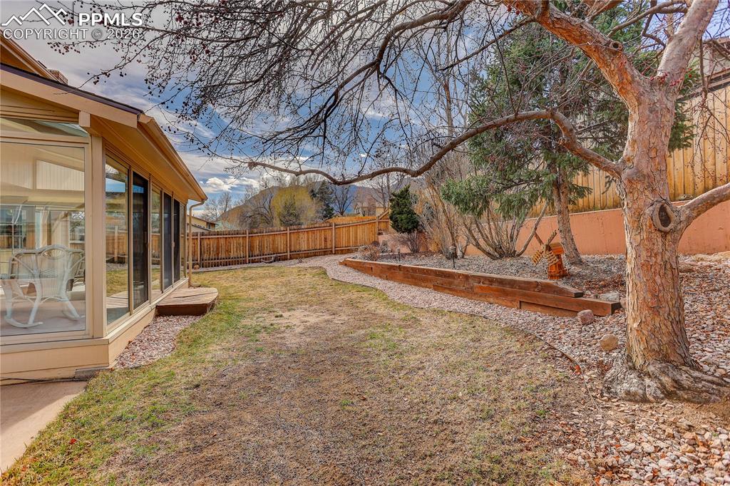Backyard with views of Cheyenne Mtn. The Cherry tree in the foreground will have wonderful blooms in a few weeks!
