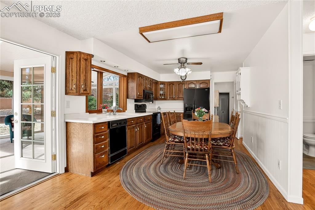 Kitchen with oak cabinets and wood floors -- all appliances convey!