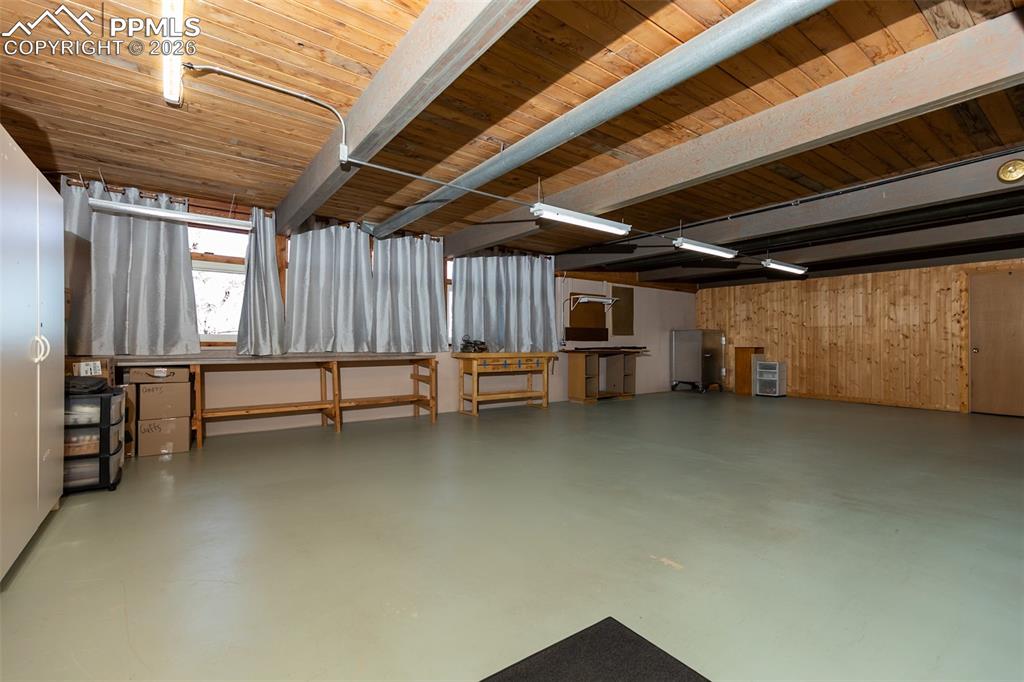 Below grade area featuring wooden ceiling and wooden walls