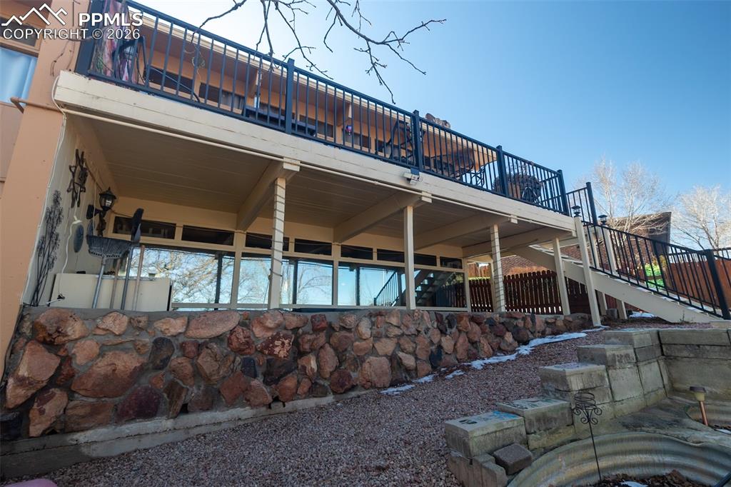 Rear view of property featuring a deck and a patio area