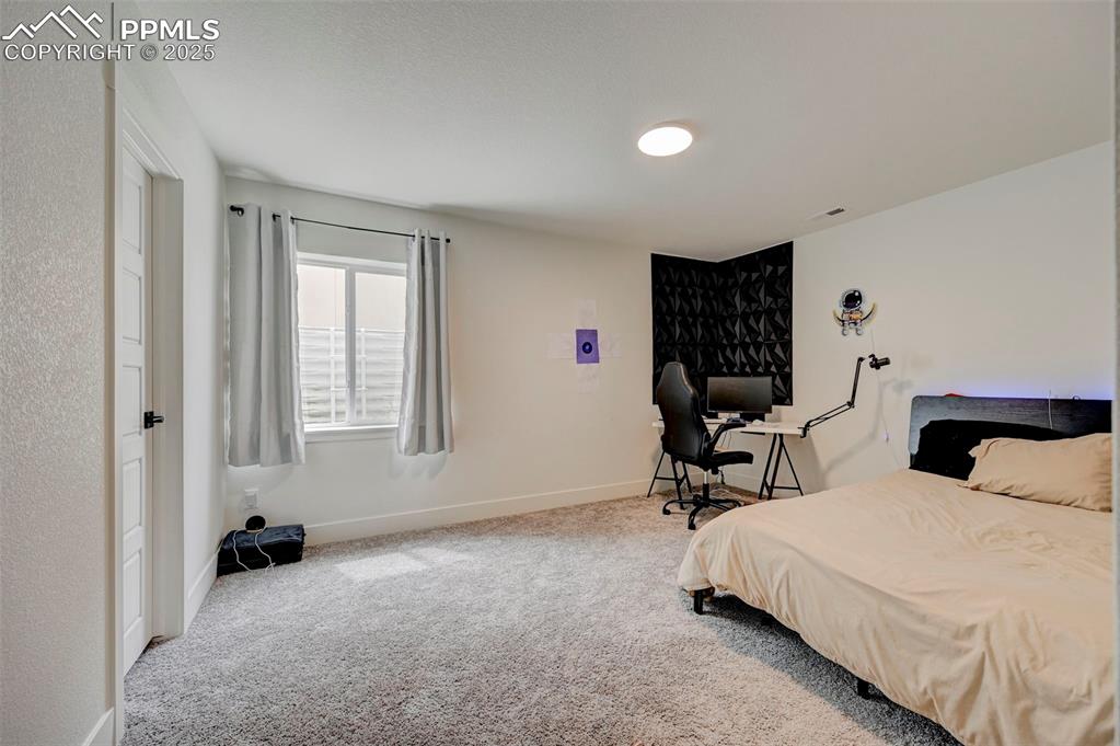 Bedroom with carpet floors and baseboards