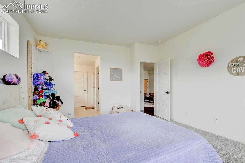 Carpeted bedroom featuring baseboards