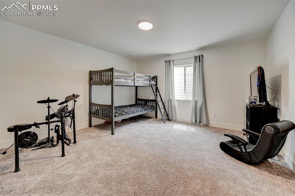 Carpeted bedroom with baseboards
