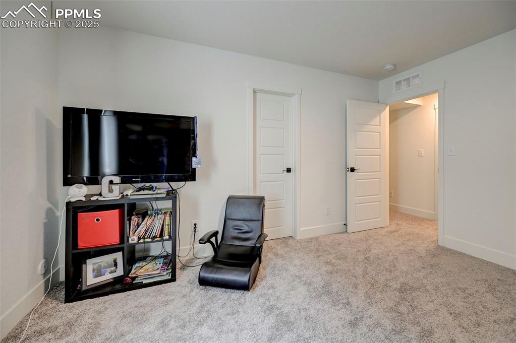 Living area with carpet flooring and baseboards