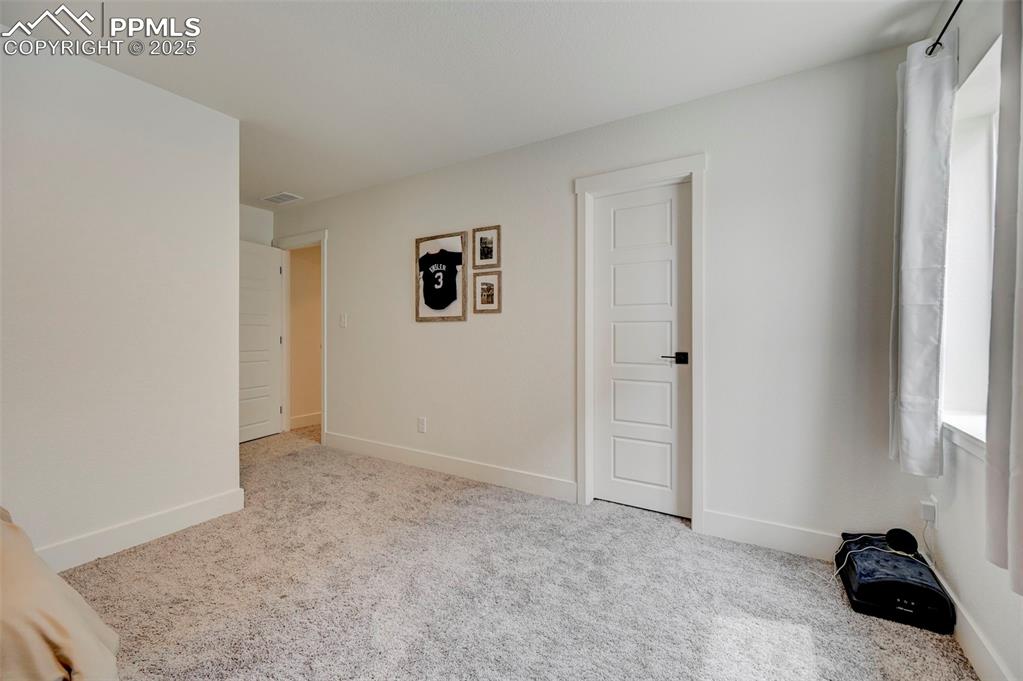 Unfurnished room featuring carpet flooring and baseboards