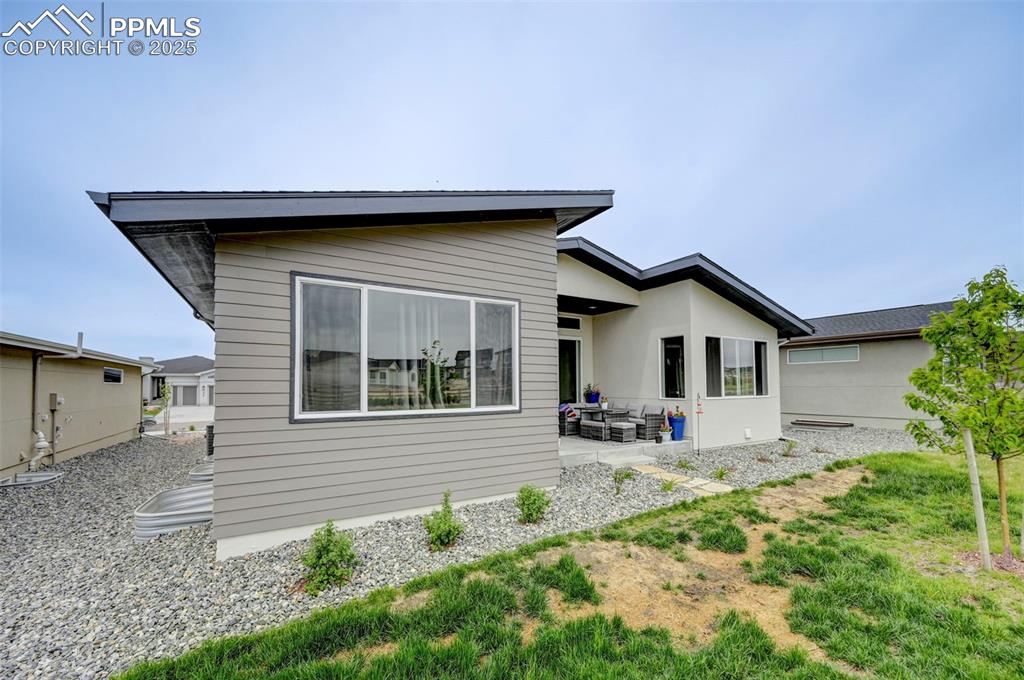 Rear view of property featuring a patio
