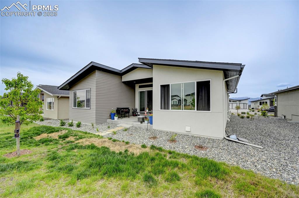 Back of property with a patio area and stucco siding