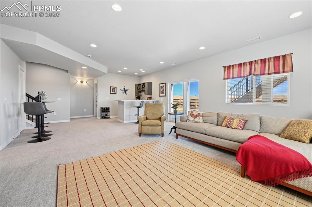 Basement family room featuring light carpet and recessed lighting