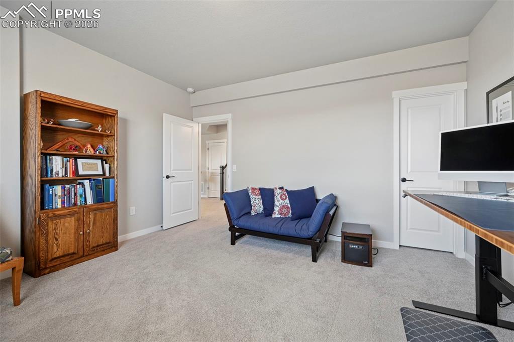4th Bedroom - Sitting room with light colored carpet and baseboards