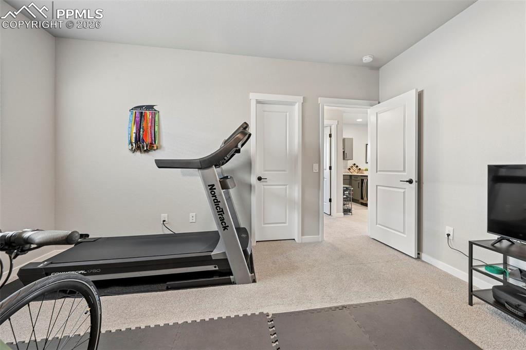 5th Bedroom - Workout area with light colored carpet and baseboards