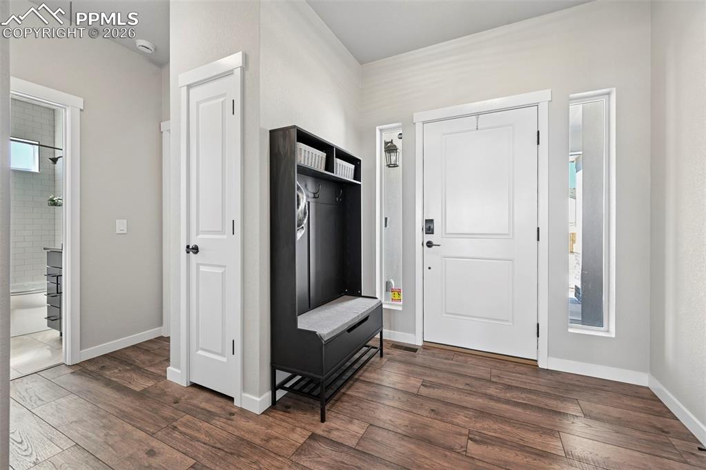 Mudroom with dark wood-style flooring