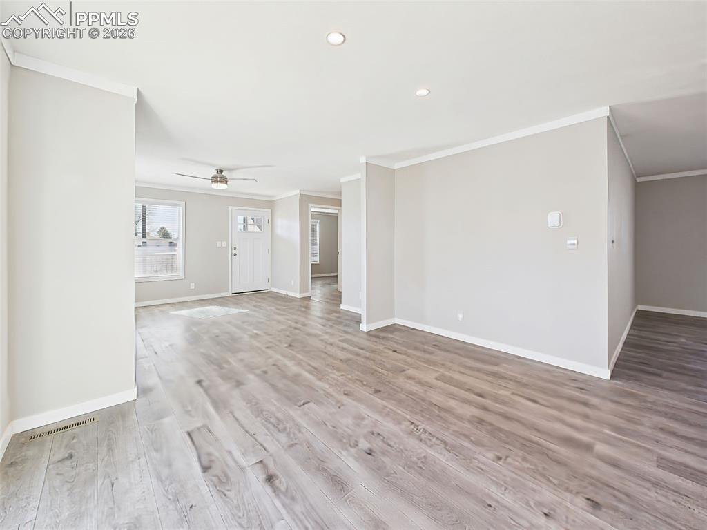 Unstaged Dining Area – Natural light pours into this flexible dining area, with direct access to the backyard deck through large sliding doors.
