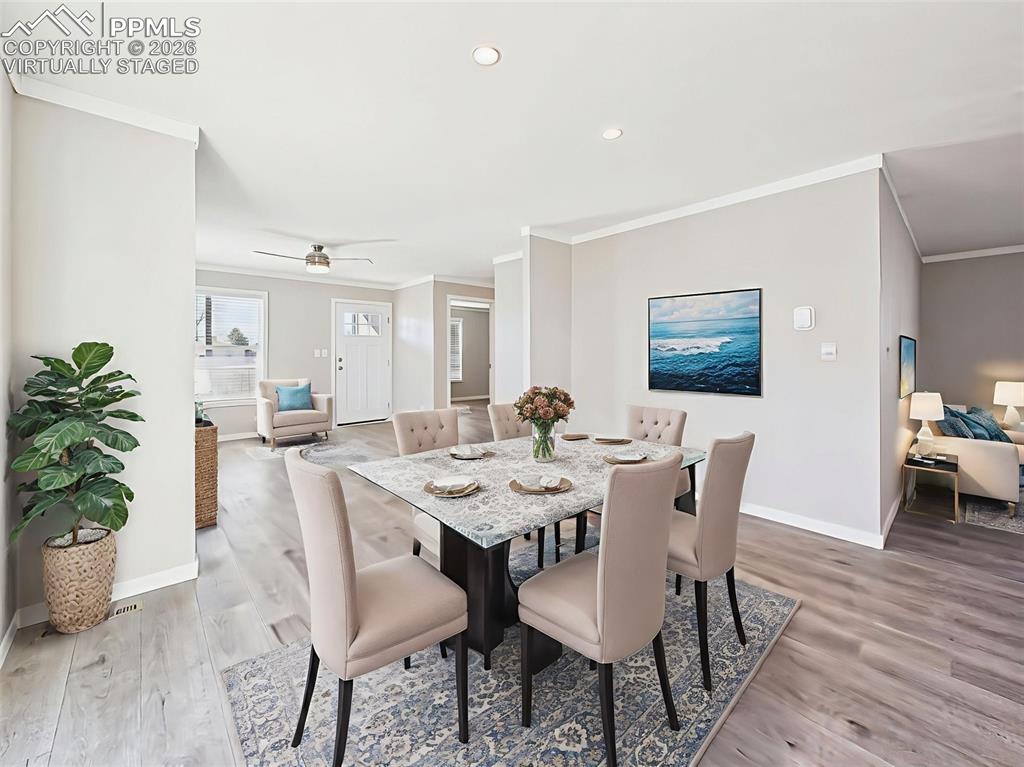 Virtually Staged Kitchen Dining Area – This inviting view illustrates how the open kitchen layout easily accommodates formal or casual dining, with direct access to both living spaces.