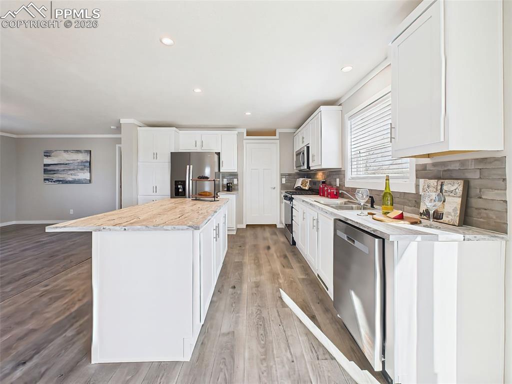 Open Layout from Kitchen – From the island, enjoy views across the light-filled living and dining areas, highlighting the home’s open-concept design and effortless flow.