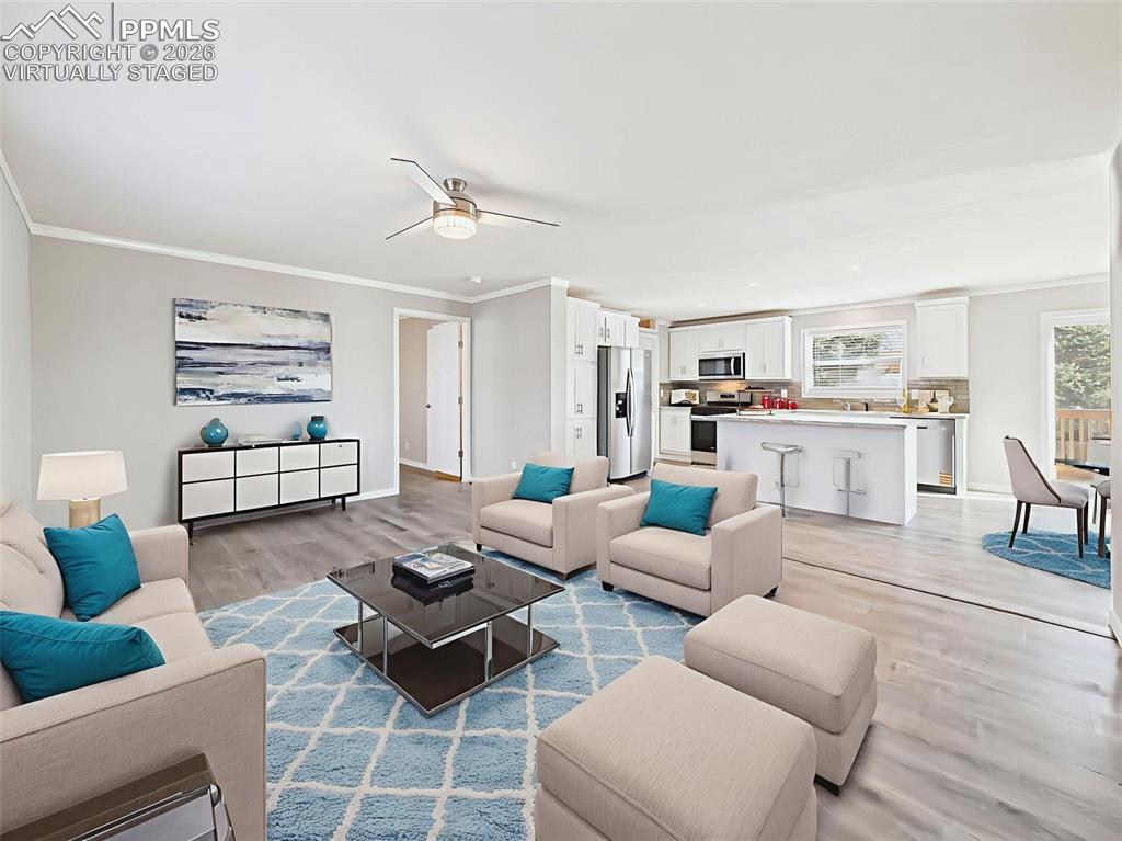 Virtually Staged Back Family Room – Furnished for maximum comfort, this back living space offers large windows, a neutral palette, and direct access to the hallway and bedroom areas.