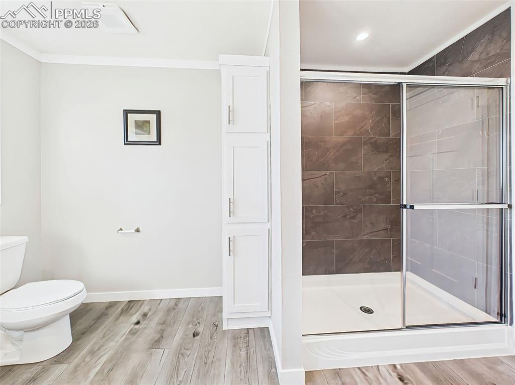 Walk-In Shower & Storage – The primary bath includes a sleek, glass-enclosed shower with rich tile surround and a built-in linen cabinet for added convenience.
