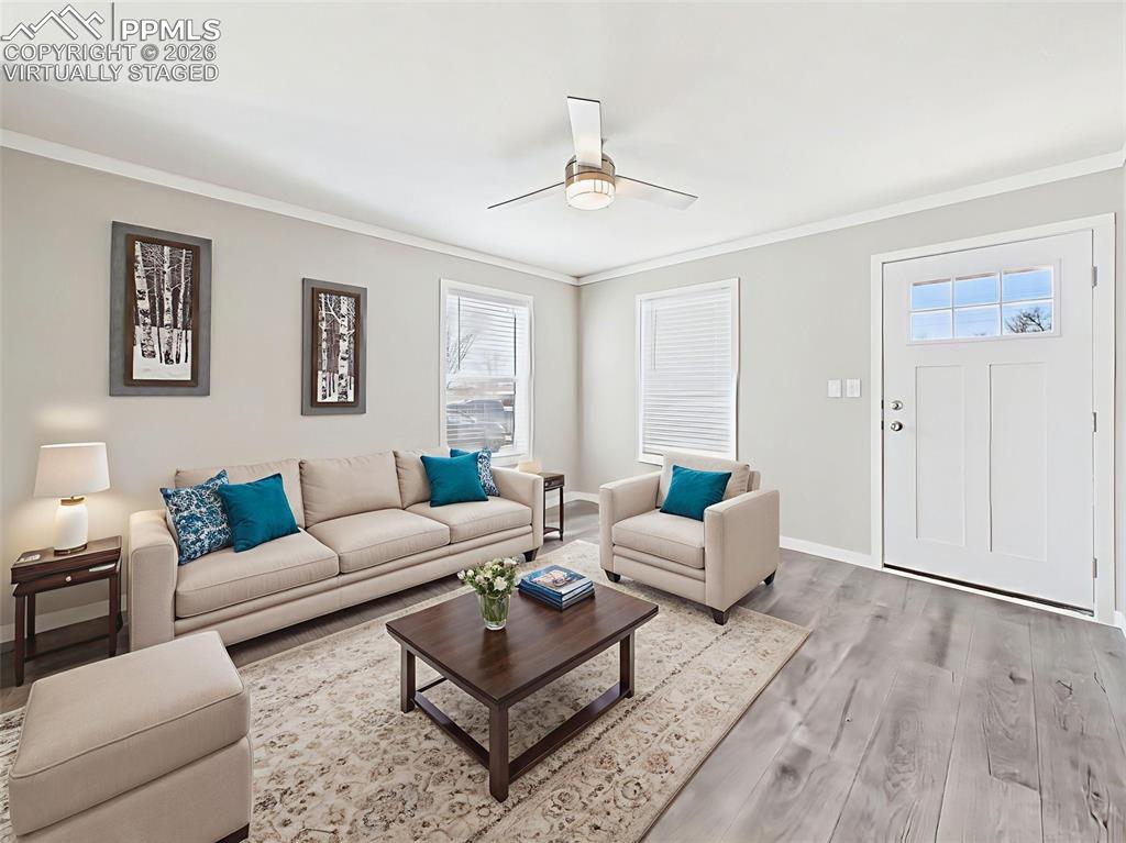 Virtually Staged Living Room – This rendered setup illustrates a warm and comfortable seating area just inside the front door, ideal for casual gatherings or relaxing evenings.