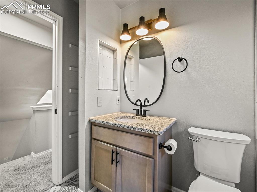 Half bath with vanity and toilet