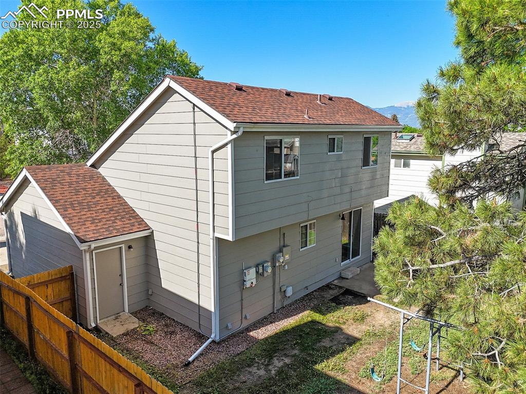 Back of house with roof with shingles