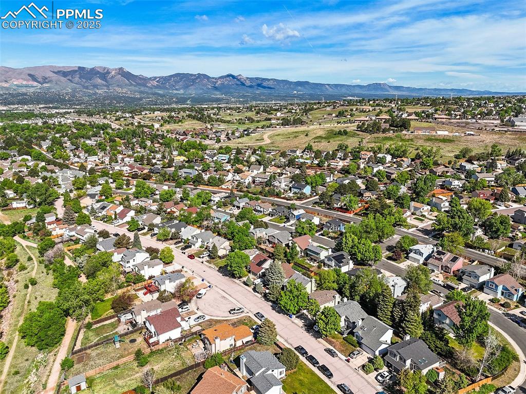 View of property location with mountains and nearby suburban area