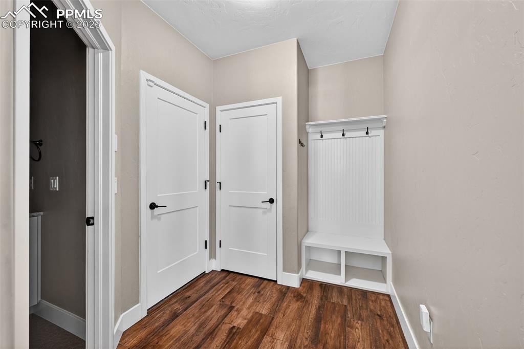 entry from garage into mud room with restroom to the left
