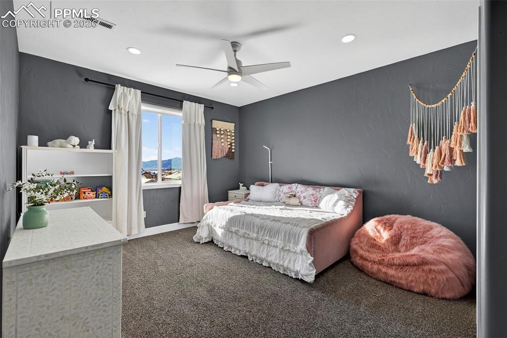 upper level bedroom  with walk in closet facing Pikes Peak