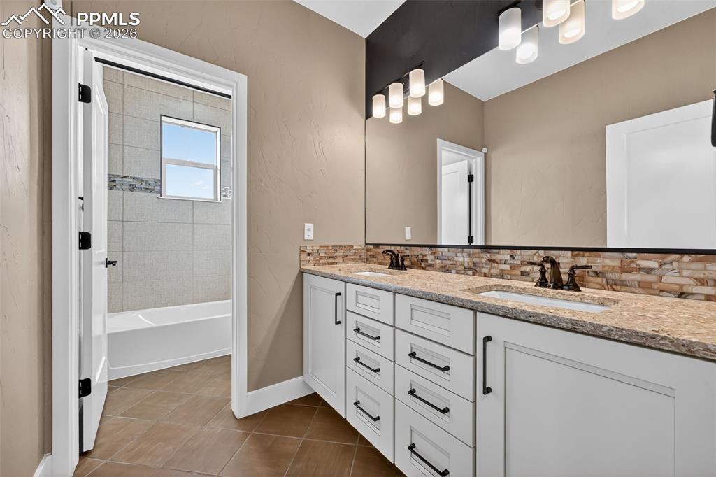 double vanity upper level bathroom with bath/shower