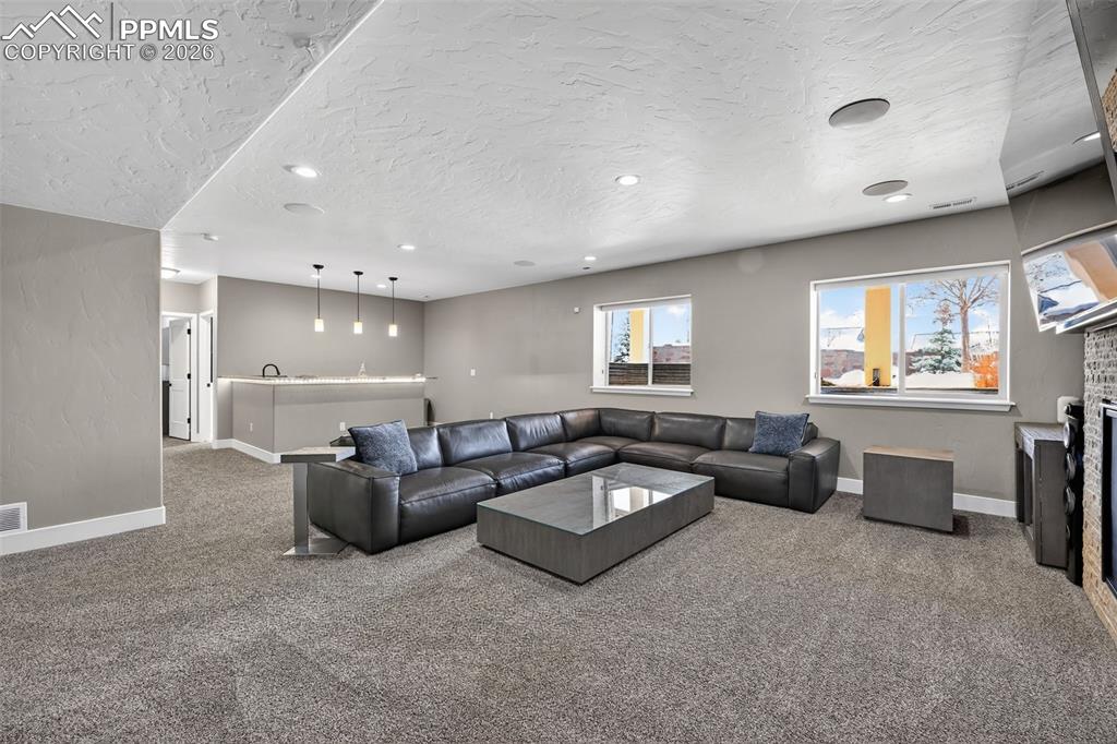 lower level living room area with open concept and wet bar