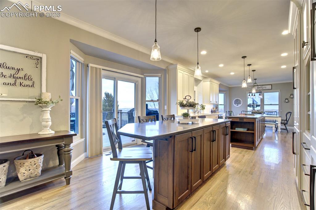 Kitchen showing the second Island with breakfast bar, bay area has sliding doors to the huge composite deck, with gas line for bbq and outdoor firepit for all your entertaining needs.  