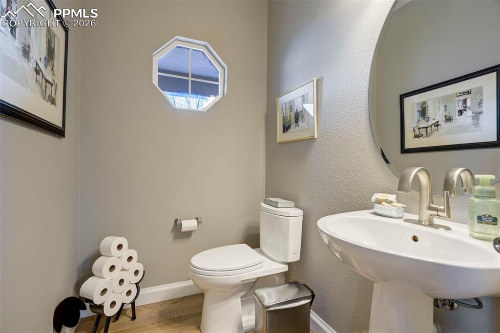 Updated, powder room on the main floor with hardwood floors.