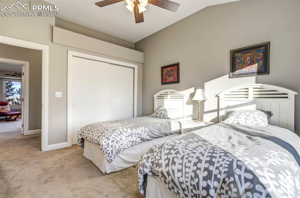 Second view of bedroom 2 showing large closet and vaulted ceiling.