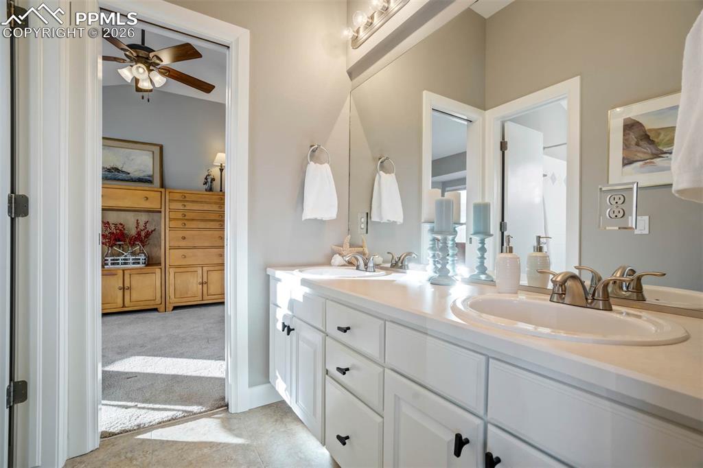 Bathroom 3, with double vanities. Tile flooring.