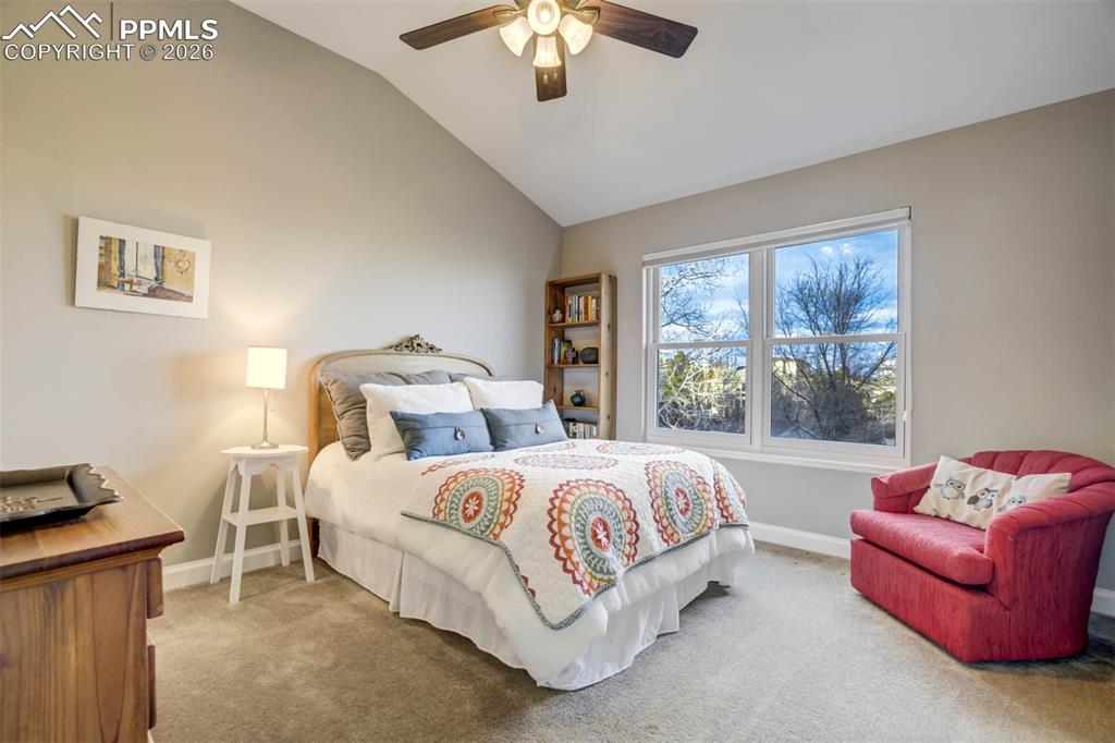 Bedroom 4 with lofted ceiling, a ceiling fan w/lights and carpet