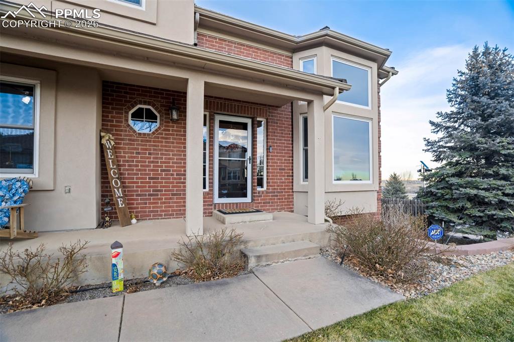 View of the covered front entry porch and the front door.