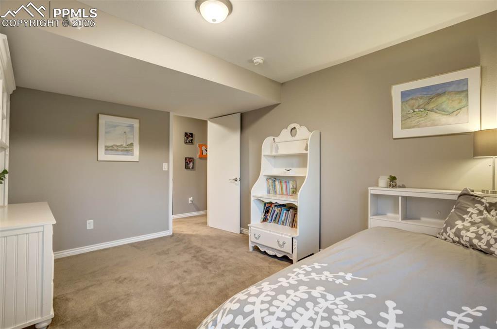  5th Bedroom(basement) with light carpet.