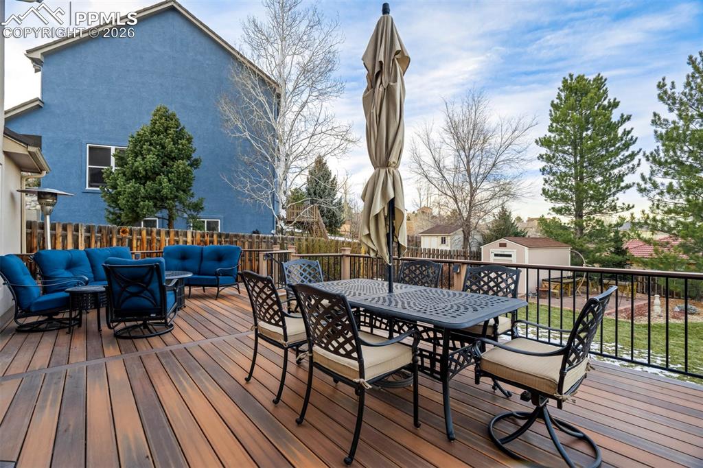 Another view of the huge composite deck, stairs down to the professionally landscaped grassed backyard. There  a storage shed and three raised flower beds.  All garden furniture is excluded.